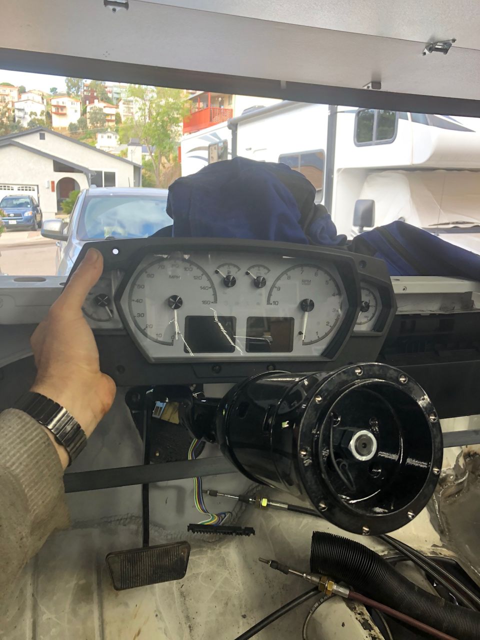 Dashboard instrument cluster and steering column assembly, with visible wiring and pedals