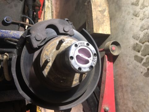 1979 Ford Bronco - A close-up view of a vehicle's wheel hub assembly, showing the brake rotor and a "FREE"/"LOCK" selector.