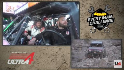 1985 Toyota Hilux - Two drivers are inside a custom off-road buggy, navigating a rocky terrain.