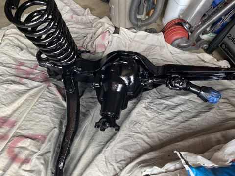1994 Ford Bronco - Front axle assembly and coil spring, likely undergoing a rebuild or restoration process.