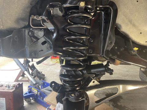 1994 Ford Bronco - Close-up view of vehicle front suspension components during a rebuild.