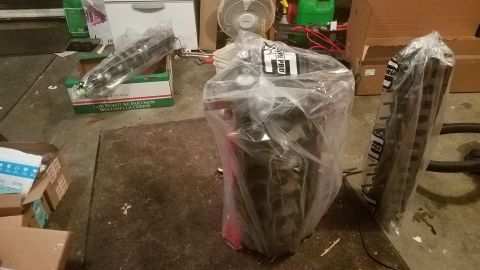 1985 Ford Bronco - Several engine components are packaged in plastic, suggesting they are new or awaiting installation.