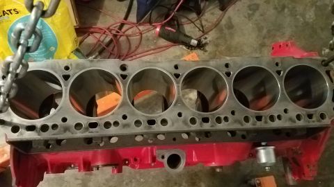 1985 Ford Bronco - A close-up view of a bare engine block, showing the cylinder bores and mounting points.