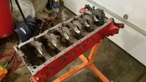 1985 Ford Bronco - Engine block on a stand, showing internal components and red paint.