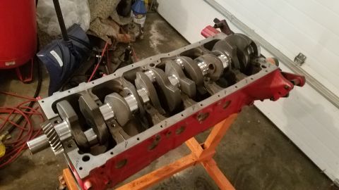 1985 Ford Bronco - Engine block with crankshaft on a stand, with a Supermotors logo in the corner.