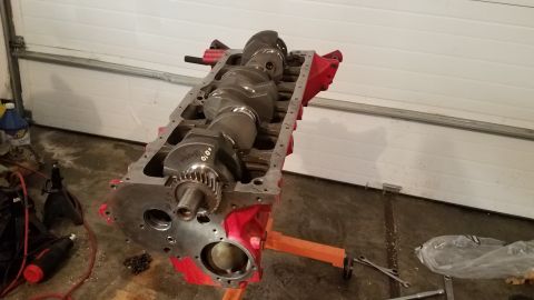 1985 Ford Bronco - Engine block with crankshaft and gear visible, likely undergoing repair or rebuild.