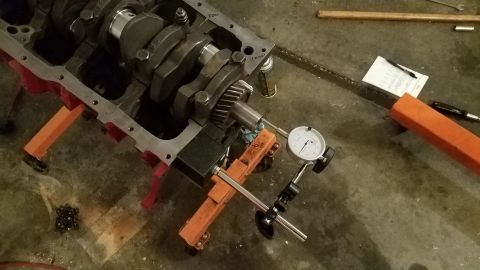 1985 Ford Bronco - Engine block assembly with crankshaft and precision measuring tools on a workshop floor.