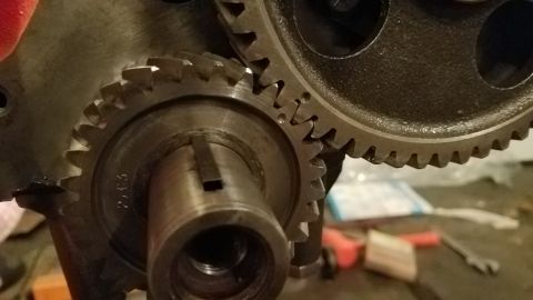 1985 Ford Bronco - Engine gears meshing together, with a visible part number on one component.