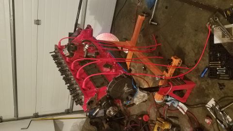 1985 Ford Bronco - Engine assembly on a stand, with tools and a garage door in the background.