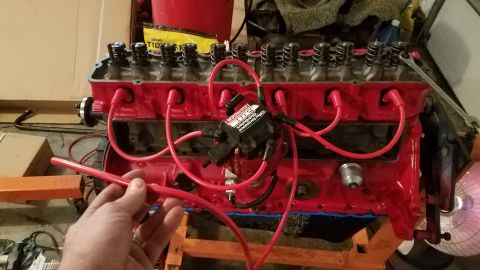 1985 Ford Bronco - Engine block with spark plug wires being worked on, possibly for repair.