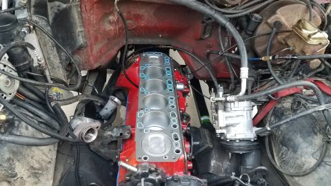1985 Ford Bronco - Engine bay view showing the exposed cylinder block and gasket during repair.
