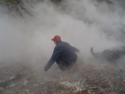 1979 Ford Bronco - A person is obscured by steam in a rocky outdoor environment. Supermotors.net logo is visible.