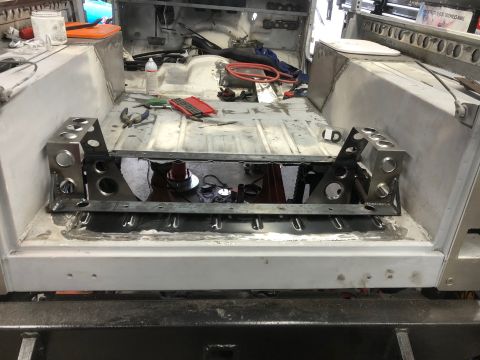 1992 Jeep Wrangler - The interior of a vehicle under construction shows a custom metal fabrication in the floor area, likely for a transmission or transfer case…