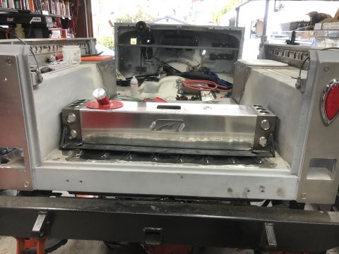 1992 Jeep Wrangler - The rear interior of a Jeep Wrangler is shown with a large, polished aluminum fuel tank installed. The tank has a red fuel cap and is mount…