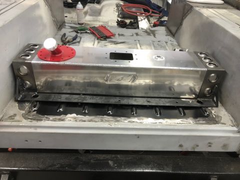 1992 Jeep Wrangler - A custom aluminum fuel tank is installed in the floor pan of a vehicle, with a red fuel filler cap visible on top. The vehicle's interior a…