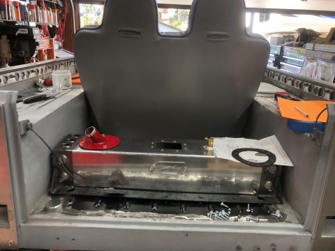 1992 Jeep Wrangler - A custom aluminum fuel tank with a red fill neck adapter is installed in the rear of a vehicle, positioned between two gray bucket seats. S…