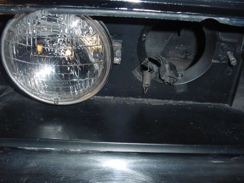 1969 Mercury Marquis - This shot shows the low beam removed and where the spring holds down the bulb. The headlight itself is attached to a bucket, which then sli…
