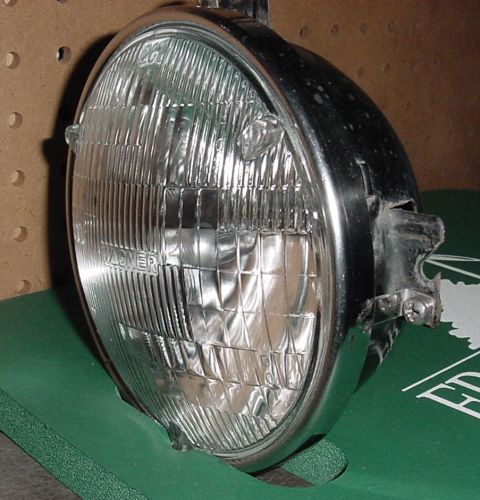 1969 Mercury Marquis - This shot shows the headlight mounted inside the bucket, and slots (two: at 12 & 3 O'clock) which slide into the adjustment screw posts.