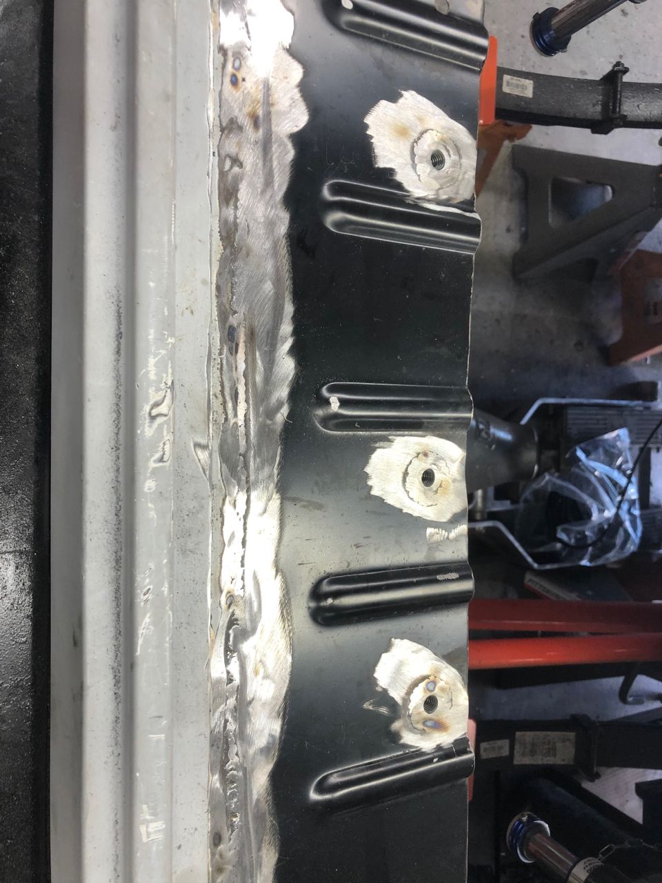 Vehicle body panel with welding and threaded mounting points.