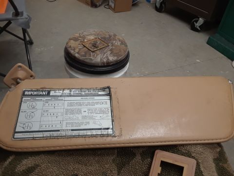 1994 Ford Bronco - A tan-colored sun visor with an "IMPORTANT" sticker detailing driving modes for Ford overdrive transmissions is shown laid flat. The visor…