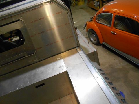 1992 Ford Bronco - A partially constructed metal structure, possibly a vehicle body or custom fabrication, is shown in the foreground. An orange Volkswagen Be…