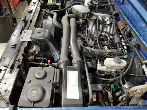 1989 Ford Bronco - Engine bay Left The dark brake fluid probably hasn't been changed in decades. The air filter is K&N. The pad for the jack handle is a scrap…