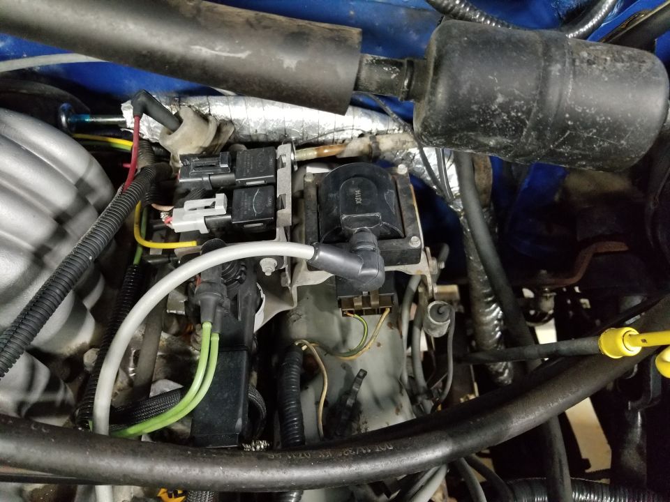 I've never seen insulation around the fuel lines, so I assume that's not factory. As with many trucks this age, the wire insulation is shrinking, exposing the wire to the coil.