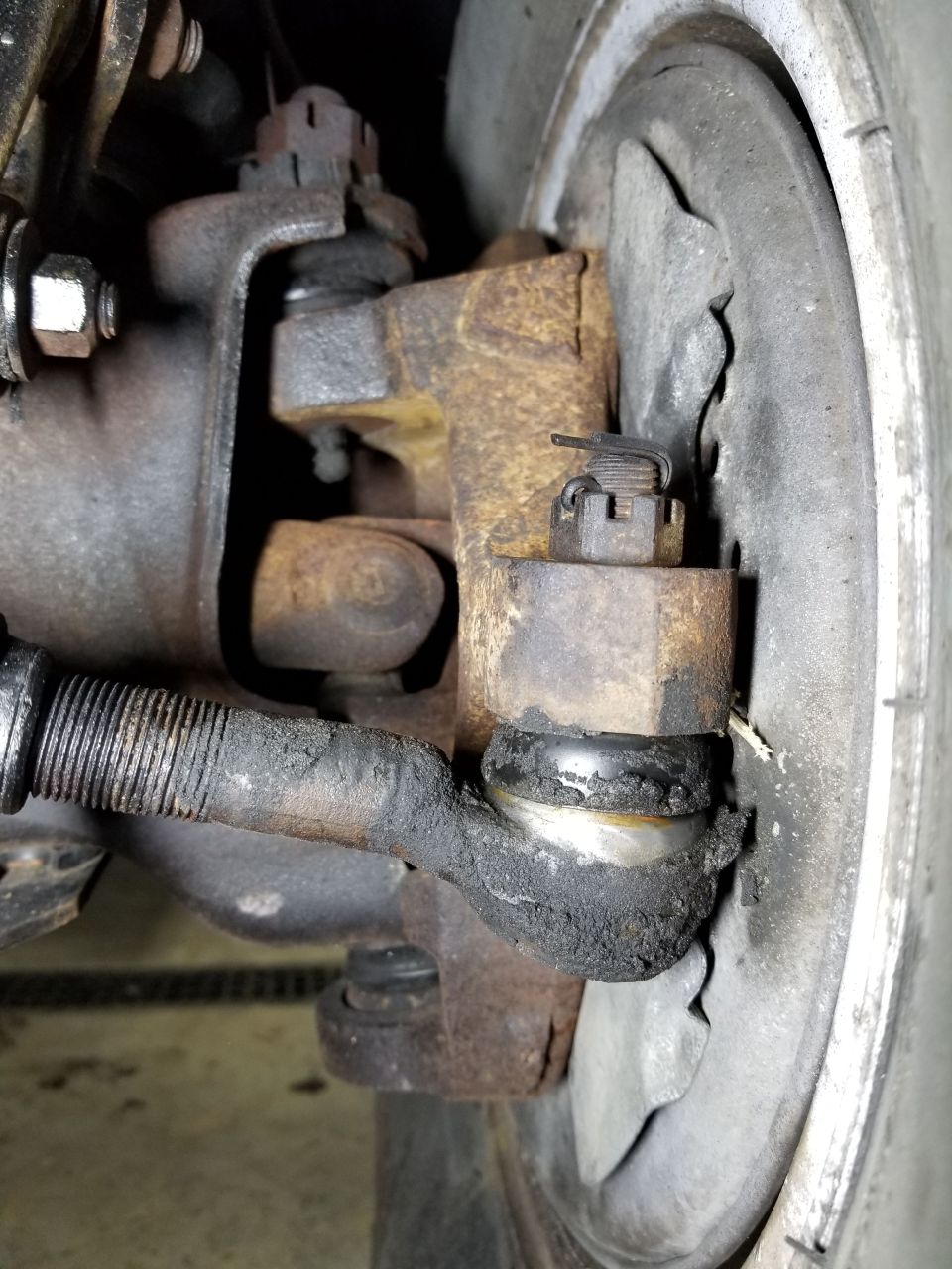 There is no detectable wear in the tie rods, but the Left ball joints are VERY loose.  The Right BJs seem OK.

UPDATE: Turns out, not only are the BJs worn - the lower one's nut isn't even tight inside the steering knuckle. And there's not enough room under the U-joint to put a wrench on it.