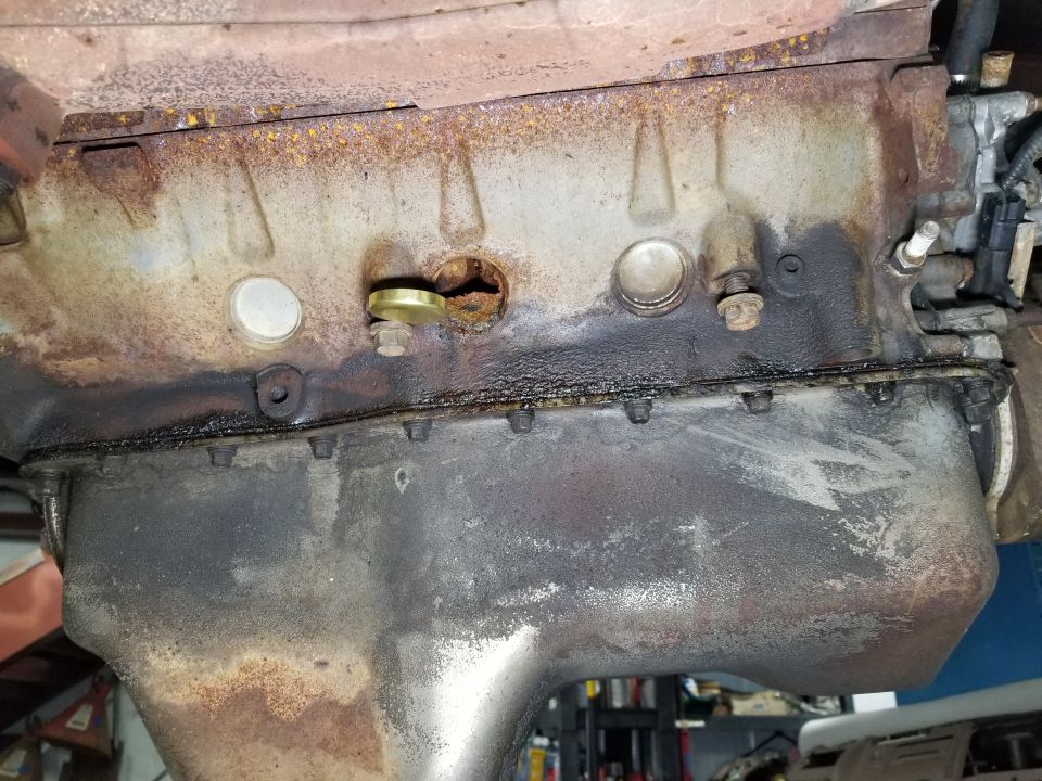 Engine oil pan and lower block with oil leaks and rust