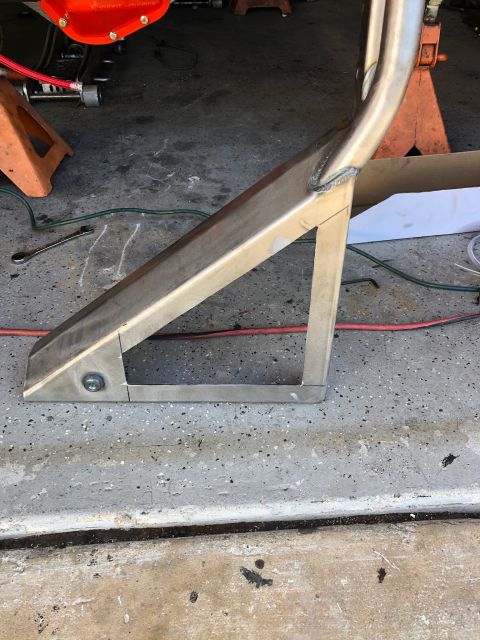 1992 Jeep Wrangler - A custom metal fabrication, likely a suspension component, is shown secured with a bolt to a concrete floor. The fabrication is made of bru…