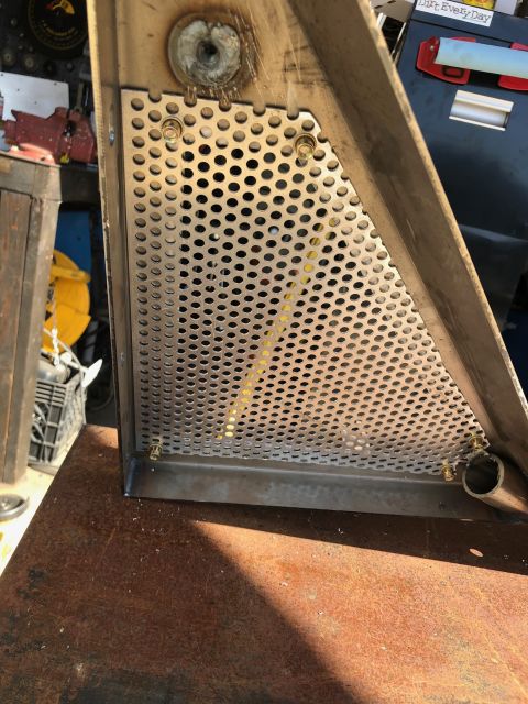 1992 Jeep Wrangler - A perforated metal plate is bolted to a triangular metal bracket, likely part of a vehicle's undercarriage or engine bay. The bracket is we…