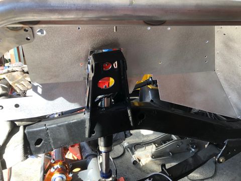 1992 Jeep Wrangler - A black metal frame structure is mounted to a silver metal panel, likely part of a vehicle's chassis. The frame has cutouts and appears to…