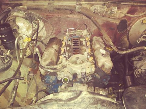1996 Ford Bronco - A close-up view of the engine bay of a Ford Bronco, showing the fuel injection system and various hoses and components.