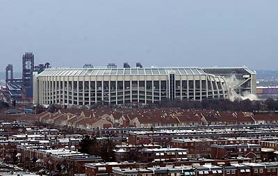 1979 Ford Bronco II - A large stadium is shown undergoing demolition, with dust and debris visible.