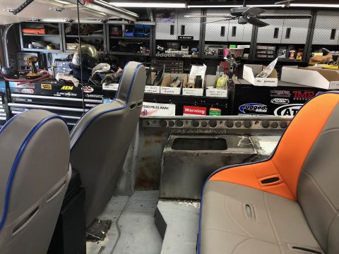 1992 Jeep Wrangler - Interior view of a vehicle project in a garage, showing two front seats and the unfinished floor and dashboard area. The seats are grey wit…