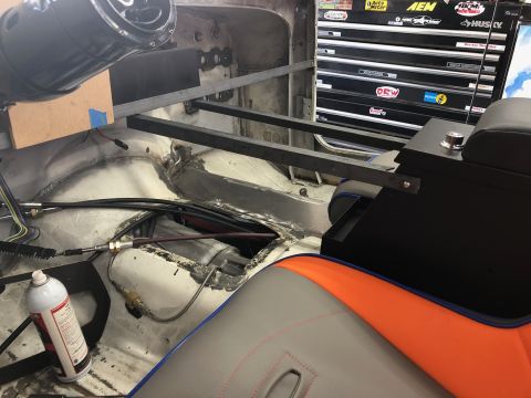 1992 Jeep Wrangler - Interior view of a vehicle build with custom metal bracing installed across the floor and a black center console with a silver knob. Variou…