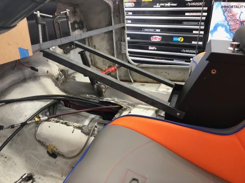 1992 Jeep Wrangler - The interior of a Jeep Wrangler shows custom metal fabrication for a center console and seat mounts. Visible components include wiring, hyd…