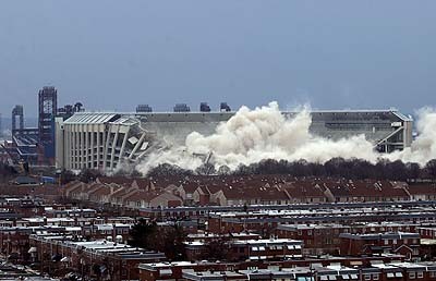 1979 Ford Bronco II - A stadium is demolished, creating a large cloud of dust that obscures the structure and surrounding buildings.