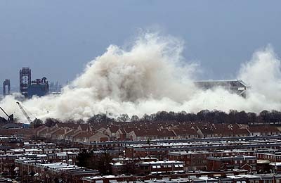 1979 Ford Bronco II - Demolition of a building creates a massive dust cloud, obscuring the structure and surrounding area.