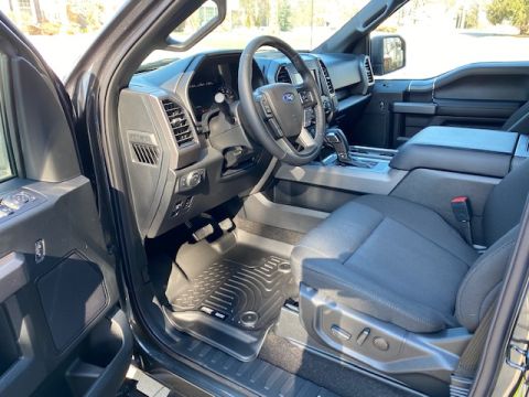 1996 Ford Bronco - The interior of a vehicle is shown, with a focus on the driver's side.