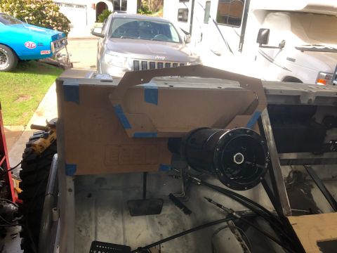 1992 Jeep Wrangler - A cardboard template is taped to the dashboard of a Jeep Wrangler, with a black steering column assembly mounted below it. The vehicle appe…