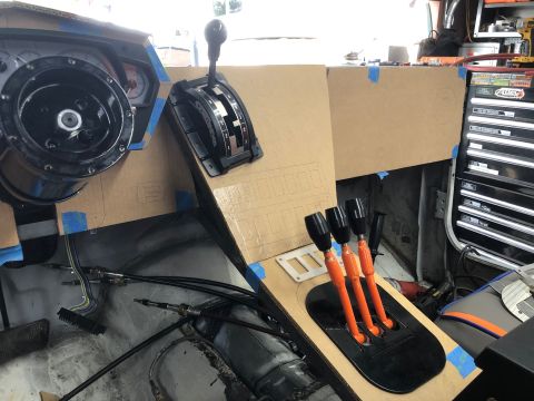 1992 Jeep Wrangler - The image shows a custom dashboard and center console being mocked up in a vehicle, likely a Jeep Wrangler. Visible components include a st…