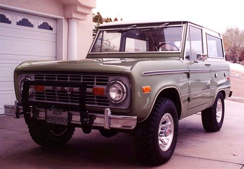 1973 Ford Bronco - This 1973 Ford Bronco features a distinctive grille, brush guard, and chrome wheels, presented in a three-quarter front view.