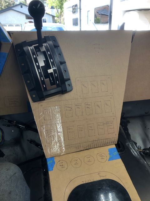 1992 Jeep Wrangler - A cardboard template for a center console is laid out in a vehicle, featuring cutouts for a shifter and various switch labels. The template…