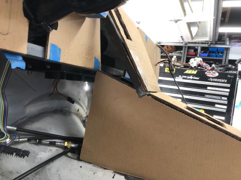 1992 Jeep Wrangler - Cardboard fitment templates taped over a dashboard opening during a build, with AEM and Husky tool chests in the garage background.