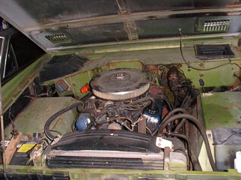1973 Ford Bronco - The engine bay of a 1973 Ford Bronco shows its V8 engine, radiator, and other components.