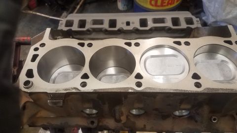 1994 Ford Bronco - A close-up view of a V8 engine block with four cylinders visible, two of which contain pistons. The engine block appears to be part of a Fo…