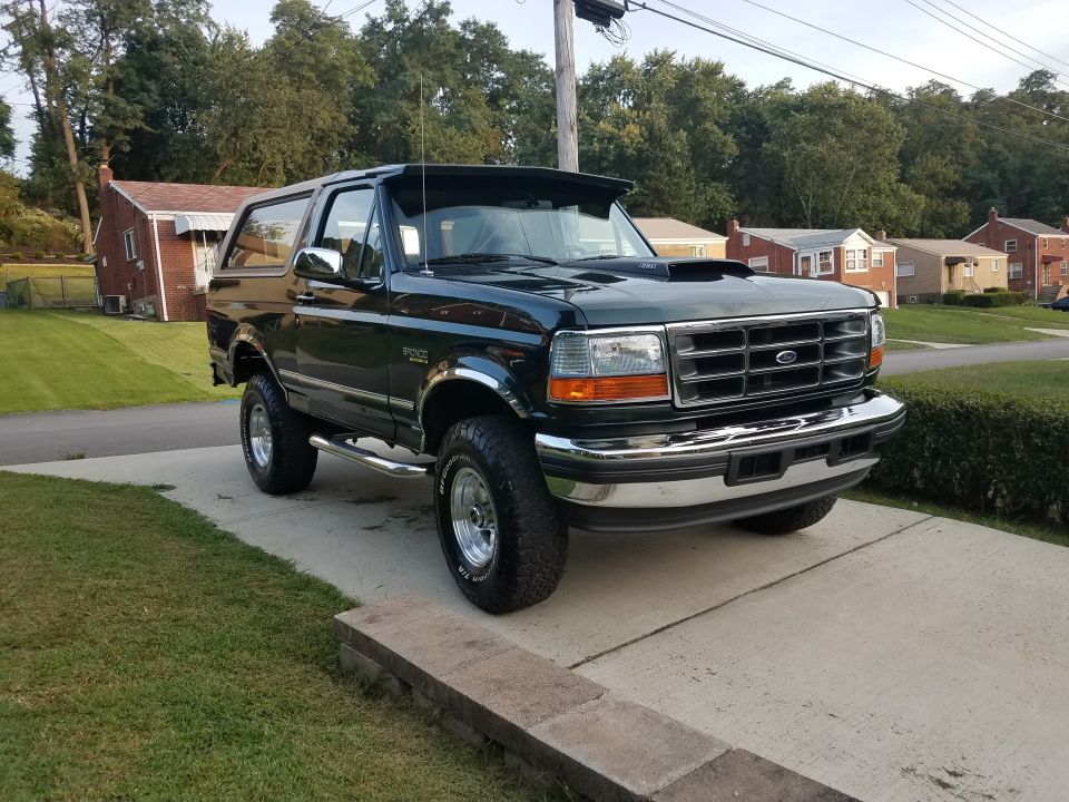 1994 Ford Bronco parked on a driveway, front 3/4 view