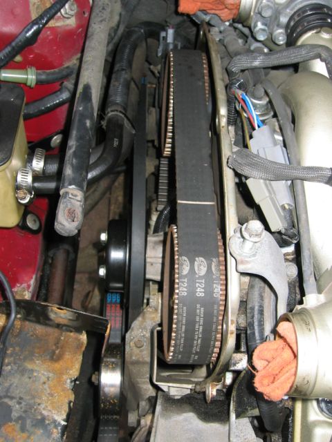 1993 Ford F-150 - Engine timing belt system with visible Gates T248 markings and associated pulleys and hoses.