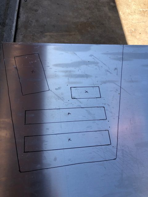 1992 Jeep Wrangler - A metal surface with black lines drawn on it, indicating cutouts or mounting points. Several rectangular shapes are marked with an 'X' insi…
